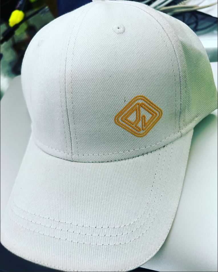 White baseball cap with gold 3D embroidery logo for corporate branding